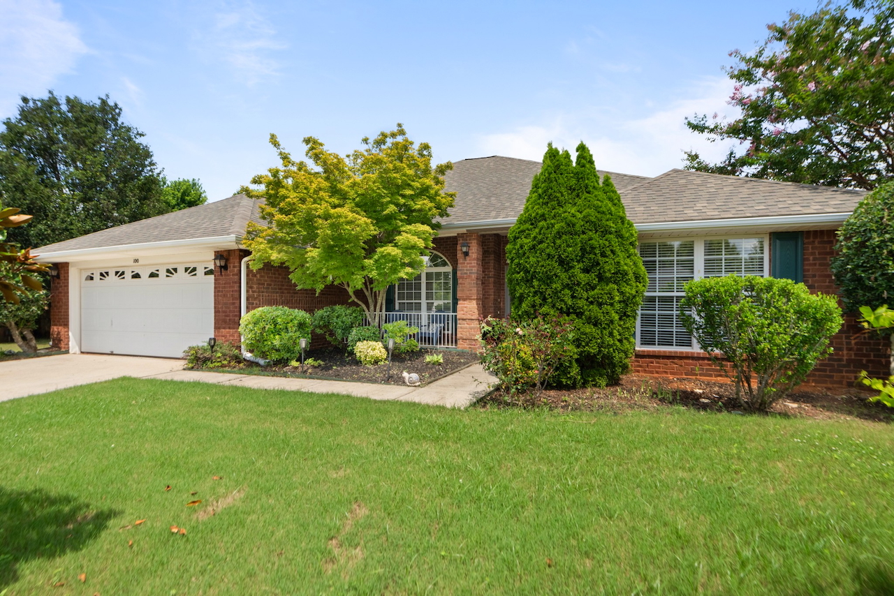 Front exterior of 100 Chantilly Lane, a one-story 4-bedroom brick home for sale in Madison, Alabama.
